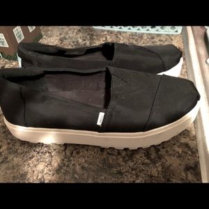 Toms black slip on shoe with cute white chunky heel.